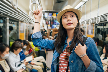 beautiful young girl traveler taking metro