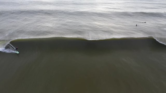 A surfer rides a big wave at the coast of Belmar, New Jersey.