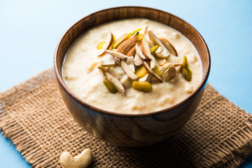 Sweet Rabdi or Lachha Rabri or basundi, made with pure milk garnished with dry fruits. Served in a bowl over moody background. Selective focus