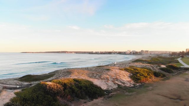 Rising Aerial Drone view of Beach At Sunset In Cronulla, Sydney Australia