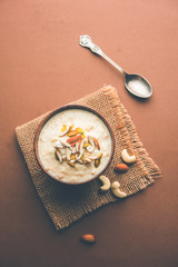 Sweet Rabdi or Lachha Rabri or basundi, made with pure milk garnished with dry fruits. Served in a bowl over moody background. Selective focus