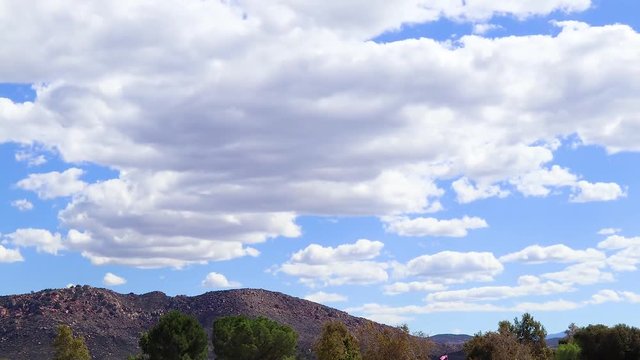 Time Lapse of Clouds coming over a hill