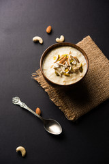 Sweet Rabdi or Lachha Rabri or basundi, made with pure milk garnished with dry fruits. Served in a bowl over moody background. Selective focus