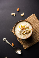 Sweet Rabdi or Lachha Rabri or basundi, made with pure milk garnished with dry fruits. Served in a bowl over moody background. Selective focus