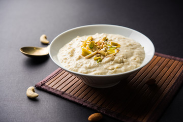 Sweet Rabdi or Lachha Rabri or basundi, made with pure milk garnished with dry fruits. Served in a bowl over moody background. Selective focus