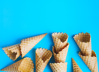 Sweet wafer cone for ice cream on blue background.