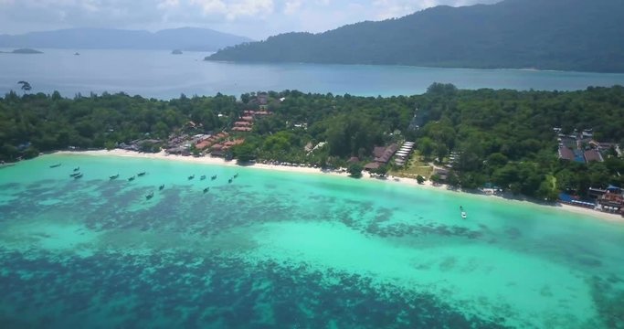 High angle aerial drone rotating RL panoramic view of colorful tropical sea, coral reef on Pattaya beach side of Ko Lipe island in Thailand. 4k 1.9:1 23.976fps