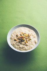 Sweet Rabdi or Lachha Rabri or basundi, made with pure milk garnished with dry fruits. Served in a bowl over moody background. Selective focus