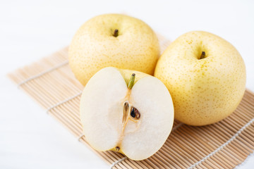 Sliced Asian pear fruit on bamboo sheet 