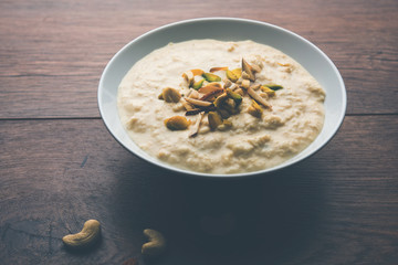 Sweet Rabdi or Lachha Rabri or basundi, made with pure milk garnished with dry fruits. Served in a bowl over moody background. Selective focus