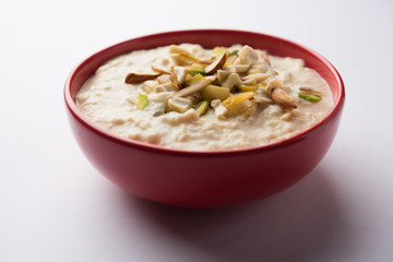Sweet Rabdi or Lachha Rabri or basundi, made with pure milk garnished with dry fruits. Served in a bowl over moody background. Selective focus