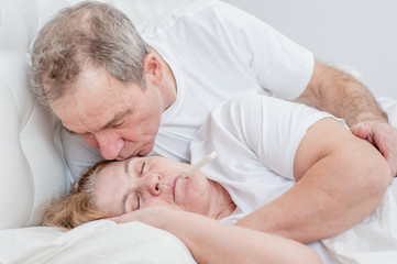 Fototapeta na wymiar Senior man kisses a sick wife