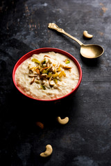 Sweet Rabdi or Lachha Rabri or basundi, made with pure milk garnished with dry fruits. Served in a bowl over moody background. Selective focus