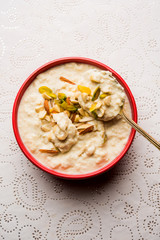 Sweet Rabdi or Lachha Rabri or basundi, made with pure milk garnished with dry fruits. Served in a bowl over moody background. Selective focus