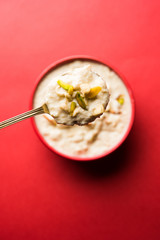 Sweet Rabdi or Lachha Rabri or basundi, made with pure milk garnished with dry fruits. Served in a bowl over moody background. Selective focus