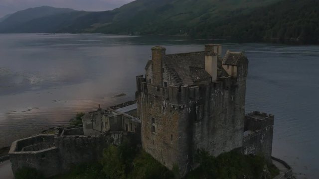 Aerial sunset view Eilean Donan castle tourists Loch Duich Scotland