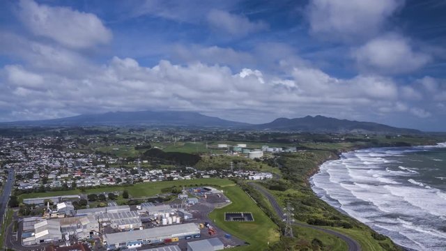 New Plymouth in New Zealand on sunny day. Timelapse video of beautiful town on the coast with clouds slowly flying inland.