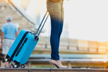 Women carry on travelling suitcase or bag, get ready for travel.
