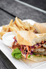 fried battered fish fillet sandwich with fries and tartar sauce