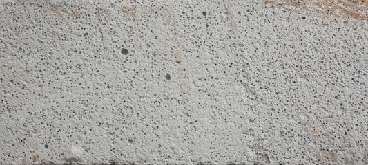 Fototapeta premium Close-up porous pattern of white concrete surface.