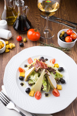 Caesar salad served in a white plate