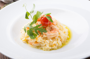Homemade shrimp risotto served elegantly on a wooden table