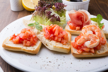 Italian sandwiches with tomatoes, shrimps and prsciutto bacon