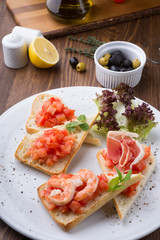 Italian sandwiches with tomatoes, shrimps and prsciutto bacon