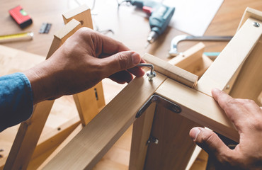 Man assembly wooden furniture,fixing or repairing house with screwdriver tool.modern living concepts