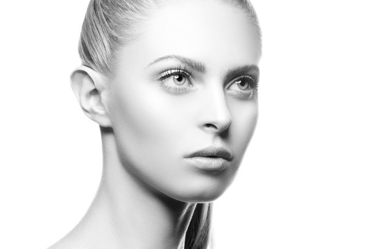 Beauty face of young caucasian model woman with natural nude make-up, clean skin. Skincare facial treatment concept. Black and white