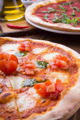 Two different pizzas freshly baked