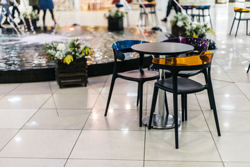 Colorful table and chairs as a part of mall interior