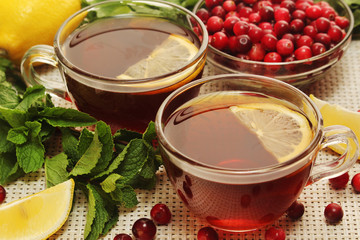 Hot tea with lemons, mint and cranberry