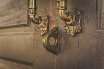 Old wooden door with lock for keys.