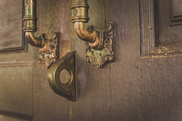 Old wooden door with lock for keys.