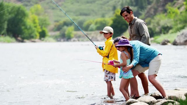 Happy American Caucasian family fishing on Colorado River on vacation outdoors