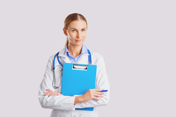 Doctor blonde in lab coat in the clinic.