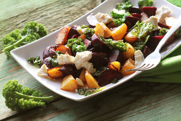 Fresh beet salad with feta cheese and fried cabbage kale