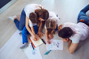 Top view of family drawing on the floor