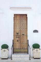 old white house and colonial door with stairs in colonial area