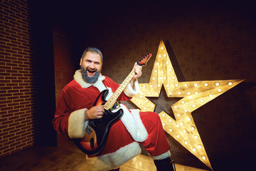 Santa Claus DJ on the background of the electric star in Christm
