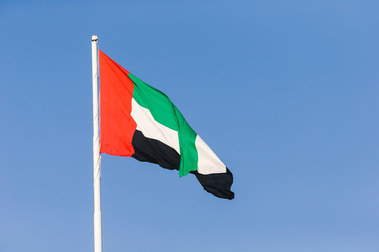 UAE flag waving in the sky, national symbol of UAE