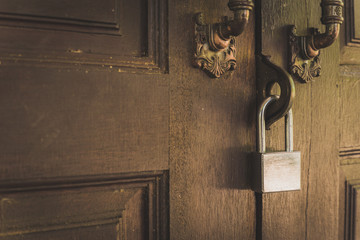 Old wooden door with lock for key with silver.
