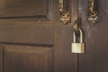 Old wooden door with lock for key with silver.