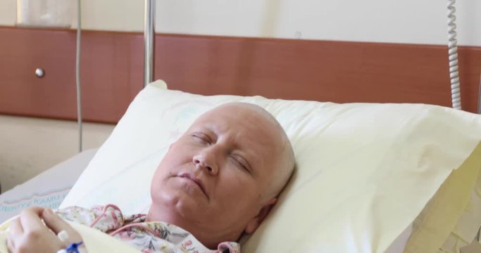 Cancer patient lying in hospital bed