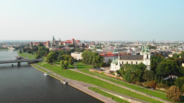 Drone aerial flying over Vistula River, Krakow towards Wawel Royal Castle Poland
