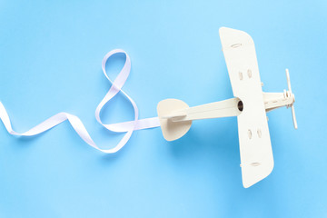 wooden children's plane on a blue background