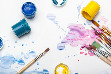 splashes of watercolor paint and painting supplies  close up