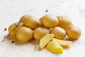 Fresh potatoes on the wood background