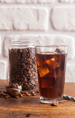 Cold brew coffee and coffee jar on the wooden table.